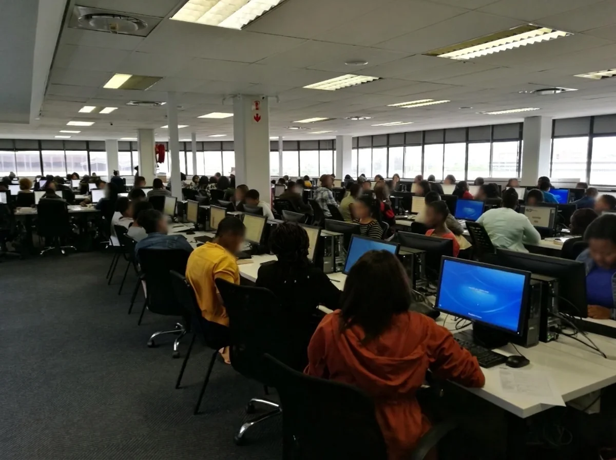 Usured operations floor — agents at dedicated workstations